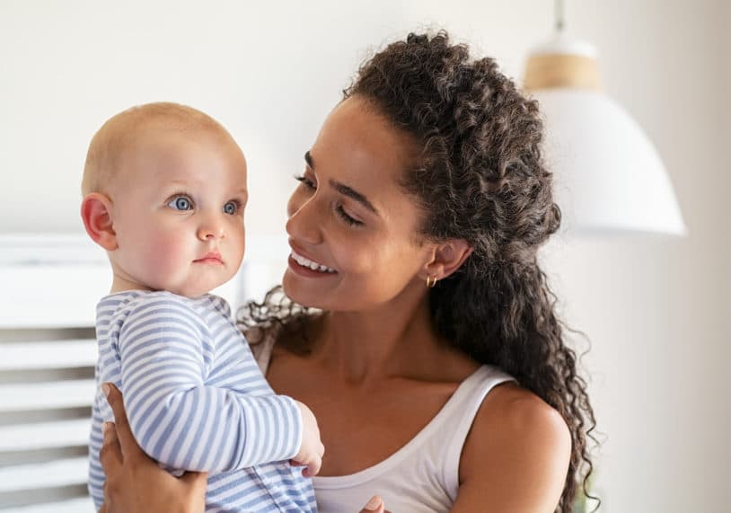 Lovely Multiethnic Mother Holding Baby